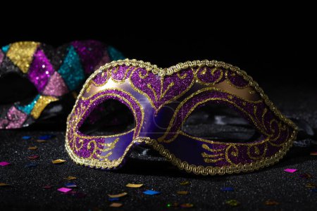 Photo for Carnival mask with confetties on black background. - Royalty Free Image