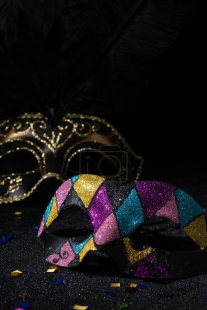 Photo for Venetian Masquerade masks on black background. Carnival party layout. - Royalty Free Image