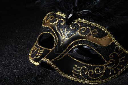 Photo for Close-up view of Masquerade gold mask with feathers on black background. - Royalty Free Image