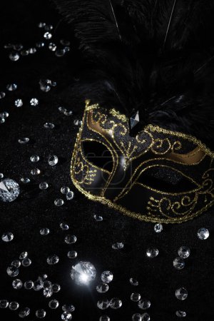 Photo for Masquerade gold mask with gemstones on black background. - Royalty Free Image