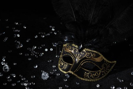 Photo for Masquerade gold mask with gemstones on black background. - Royalty Free Image