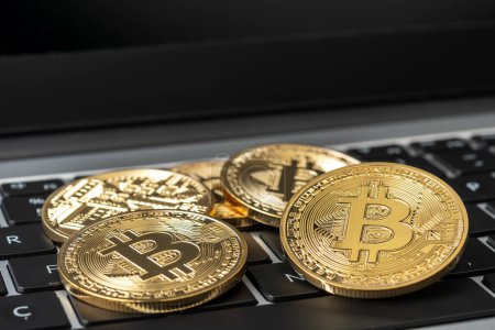 Photo for Bitcoin cryptocurrency gold coins on laptop. - Royalty Free Image