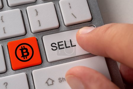 Photo for Sell bitcoin concept. Close up keyboard button choice of selling cryptocurrency bitcoin to get profit. - Royalty Free Image