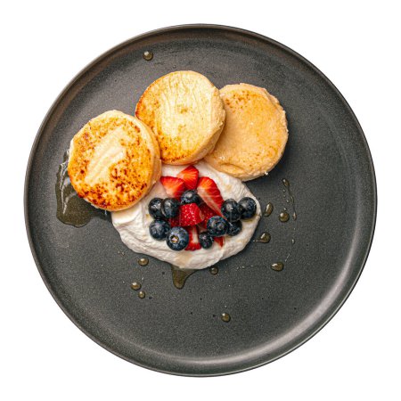 Photo for Isolated cottage cheese syrniki pancakes with cream and berries - Royalty Free Image