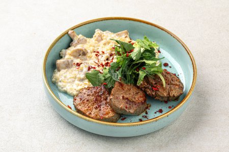 Photo for Portion of beef medallions and garnish with mushrooms - Royalty Free Image