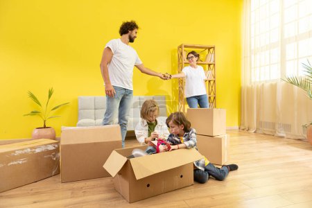 Photo for Happy family moving in a new home their kids are very excited they take a sit with all family on the sofa in the large living room and enjoy the time together. Family - Royalty Free Image