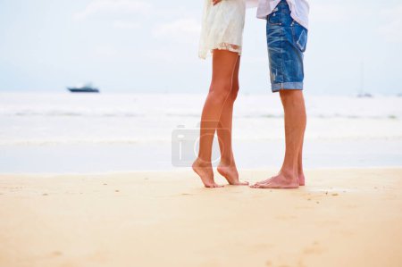 Foto de Cerca de los pies masculinos y femeninos en la arena - Imagen libre de derechos