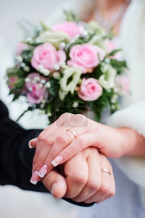 Photo for Wedding concept. Close-up of bridal and groom hands with a golden rings on it. - Royalty Free Image
