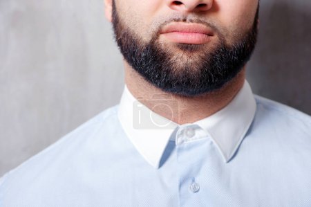 Photo for Perfect beard. Close-up of young bearded man standing against grey background - Royalty Free Image