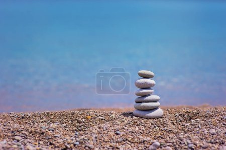 Photo for Stack of pebble stones with sea on the background - Royalty Free Image
