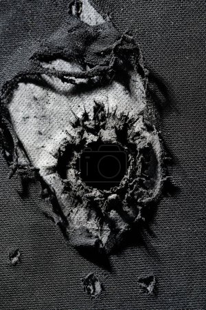 Photo for Bullet hole in composite body armour. - Royalty Free Image