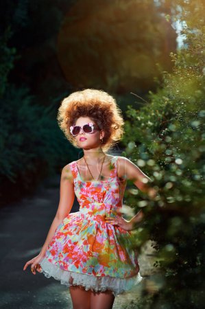 Téléchargez les photos : Portrait de fille de la mode en robe rose et coiffure dans le parc
. - en image libre de droit