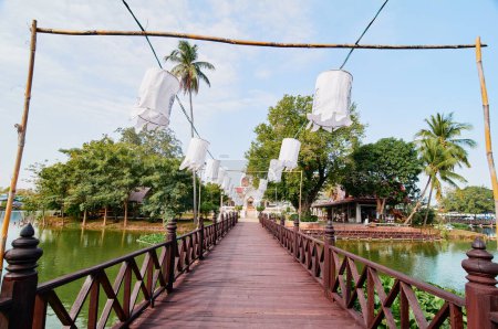 Photo for Lanterns hang to decorate the bridge in front of the temple in Sukhothai Old City Park - Royalty Free Image