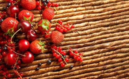 Photo for Strawberries dropped on the basket surface. - Royalty Free Image