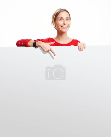 Photo for Your text here. Studio portrait of pretty young woman showing empty blank board with copy space - Royalty Free Image