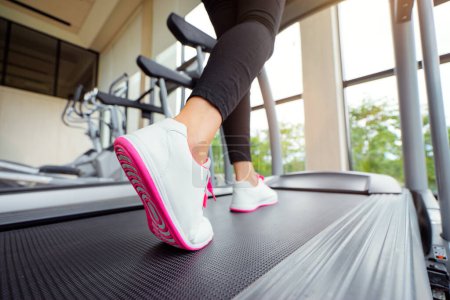 Photo for Sport concept. Close up of running female feet in sneakers in gym. - Royalty Free Image