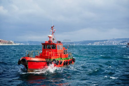 Tugboat - Rescue red vessel on a cruise at sea