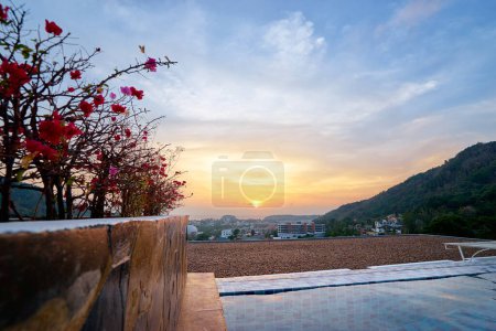 Photo for Swimming pool in sunset time with beautiful sea and city view. - Royalty Free Image