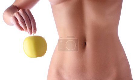 Foto de Concepto de dieta. Primer plano del delgado cuerpo femenino. Manzana en brazos. Aislado sobre fondo blanco. - Imagen libre de derechos