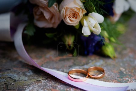Photo for Couple of gold wedding rings with flowers - Royalty Free Image