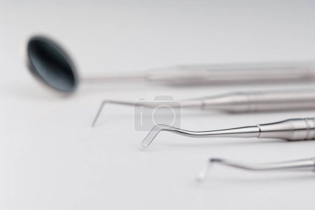 Photo for Basic dentist tools on white table. - Royalty Free Image