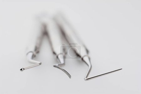 Photo for Basic dentist tools on white table. - Royalty Free Image