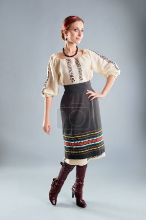 Foto de Mujer ucraniana joven posando en tela tradicional de moda sobre fondo gris. - Imagen libre de derechos