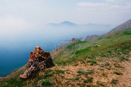 Téléchargez les photos : Paysage estival avec colline verdoyante et montagnes au bord de la mer. - en image libre de droit