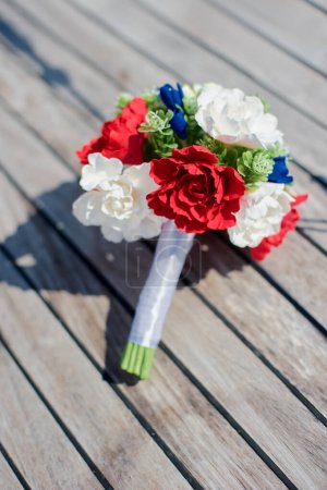 Photo for Beautiful bridal bouquet with blue, red and white flowers. - Royalty Free Image