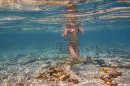 Photo for Young woman snorkeling underwater in the sea corals and fishes. - Royalty Free Image