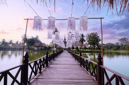 Photo for Lanterns hang to decorate the bridge in front of the temple in Sukhothai Old City Park - Royalty Free Image