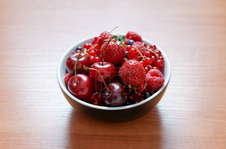 Photo for Strawberries, cherries, currant on the wooden surface. - Royalty Free Image