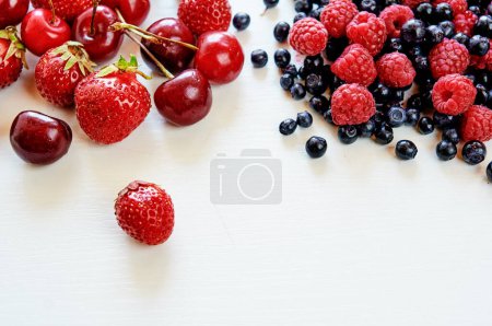 Photo for Berries dropped on the white surface. - Royalty Free Image