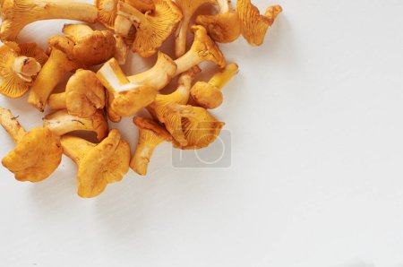 Photo for Vegetarian cuisine. Chanterelle mushrooms on white table. - Royalty Free Image