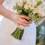 Wedding details. Close up of female hands holding bridal bouquet.