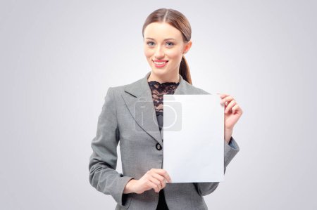 Photo for Beautiful young business woman in formal wear holding blank card. Isolated on white background smiling female portrait. - Royalty Free Image