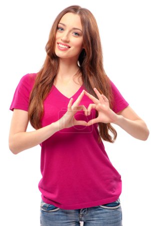 Photo for Beauty in love. Happy young woman keeping hands in a shape of heart while standing against white background - Royalty Free Image