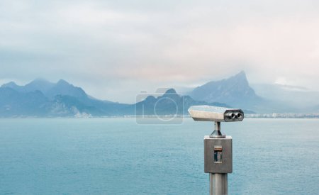 Photo for Coin Operated Binocular viewer next to the waterside promenade in Antalya looking out to the bay and city. - Royalty Free Image