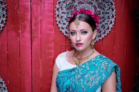 Photo for Portrait of beautiful young caucasian woman in traditional indian clothing sari with bridal makeup and jewelry. - Royalty Free Image