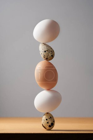 Photo for Egg cairn on white background, five eggs tower, simplicity harmony and balance, zen sculptures. - Royalty Free Image