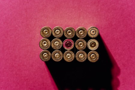 Photo for Small caliber cartridges on a red background. - Royalty Free Image