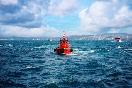 Tugboat - Rescue red vessel on a cruise at sea
