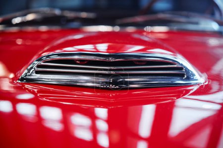 Details of red retro car hood.