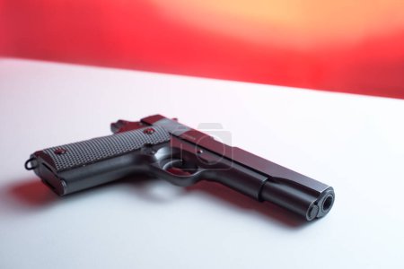 Photo for Big black gun pistol on white table. - Royalty Free Image