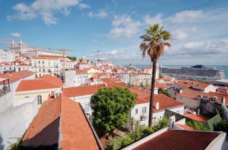Beutiful view of old town in Lisbon. Red tiled roofs and blue sky.