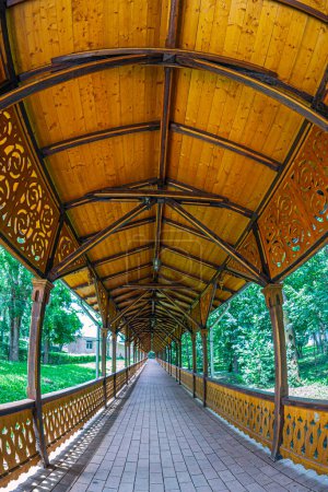 Photo for Covered wooden imperial colonnade from Buzias city park, Timis county, Romania. It was created in 1875 for the walks of the Empress of Austria. It impresses with its 500 m length, unique in Europe. - Royalty Free Image