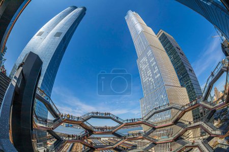 Photo for New York, USA - March 8, 2020: The Vessel, project by architect Thomas Heatherwick, also known as Hudson Yards Staircase, in Manhattan. Skyscrapers in background. - Royalty Free Image