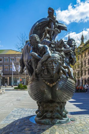 Photo for NUREMBERG, GERMANY-APRIL 30, 2023: Fountain of the Ship of Fools (Narrenschiffbrunnen), sculptor Jurgen Weber. The bronze sculpture shows a boat as a metaphor for the world threatened with extinction. - Royalty Free Image