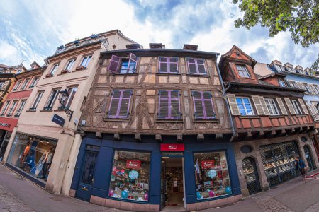 Photo for COLMAR, FRANCE - MAY 5, 2023: Streets with traditional medieval Alsatian buildings, shops and tourists. First mentioned by Charlemagne in 884. The city is renowned for its well-preserved old town. - Royalty Free Image