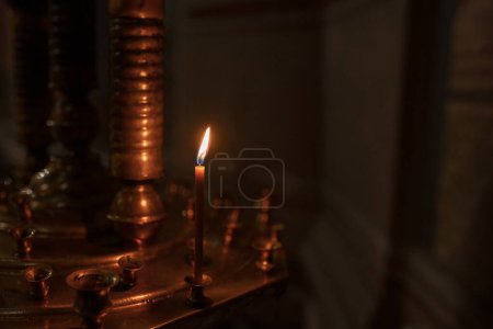 The atmosphere of the church, candles and yellow lights, bokeh background